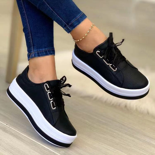 Black lace-up platform sneakers, round toe, white-trim sole, bow at top