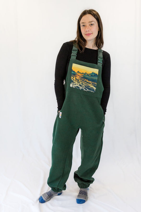Dark green fleece overalls with relaxed legs, cuffed hems, and adjustable overall straps
