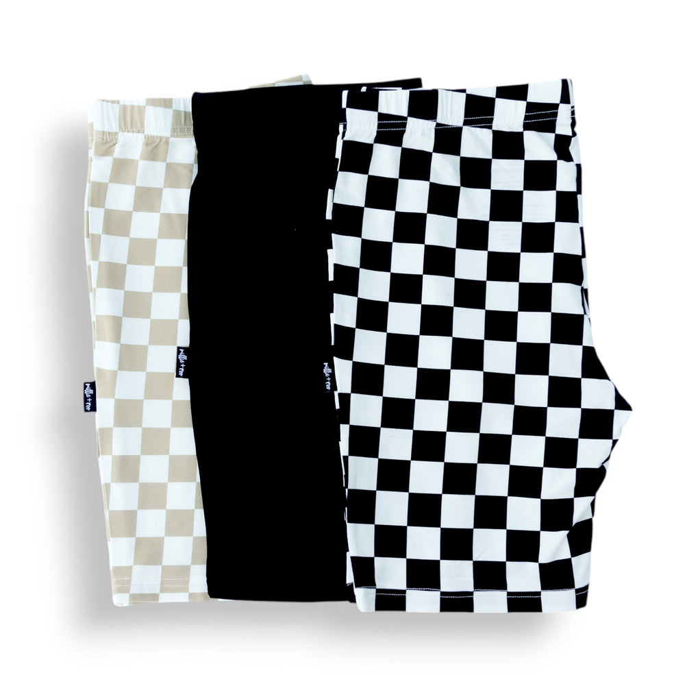 3-pack biker shorts folded: tan check, solid black, black-and-white check