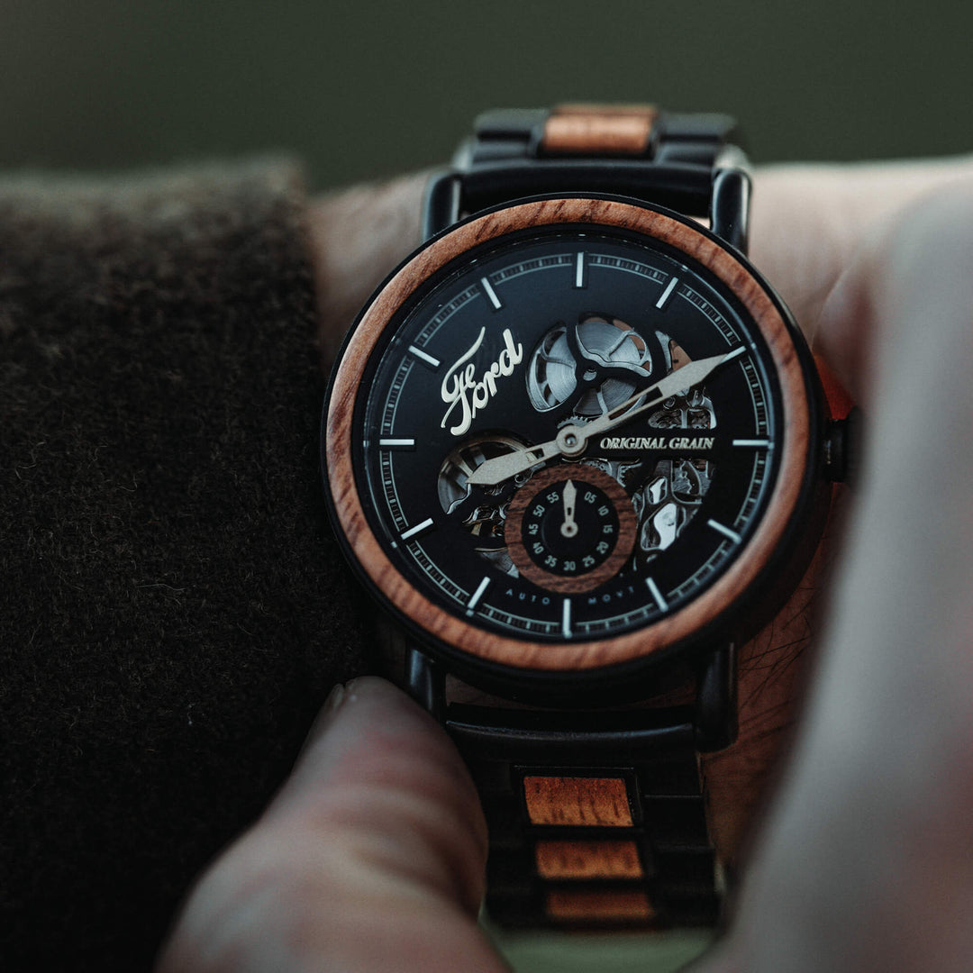 Automatic 40mm watch on wrist, black skeleton dial with wood-ring bezel and crown