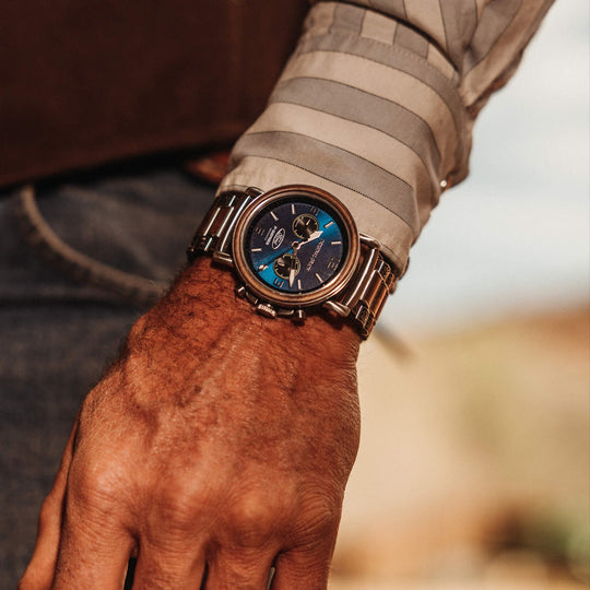 Mechanical chrono 44mm on wrist, blue dial, wood bezel, metal links, patterned bracelet