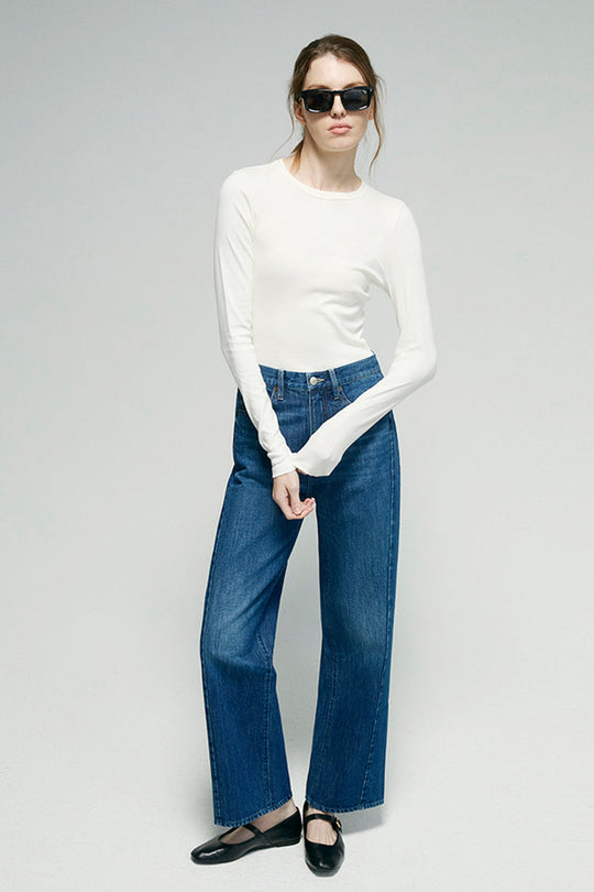 Blue denim ankle jeans with wide leg, front button closure, and front pockets