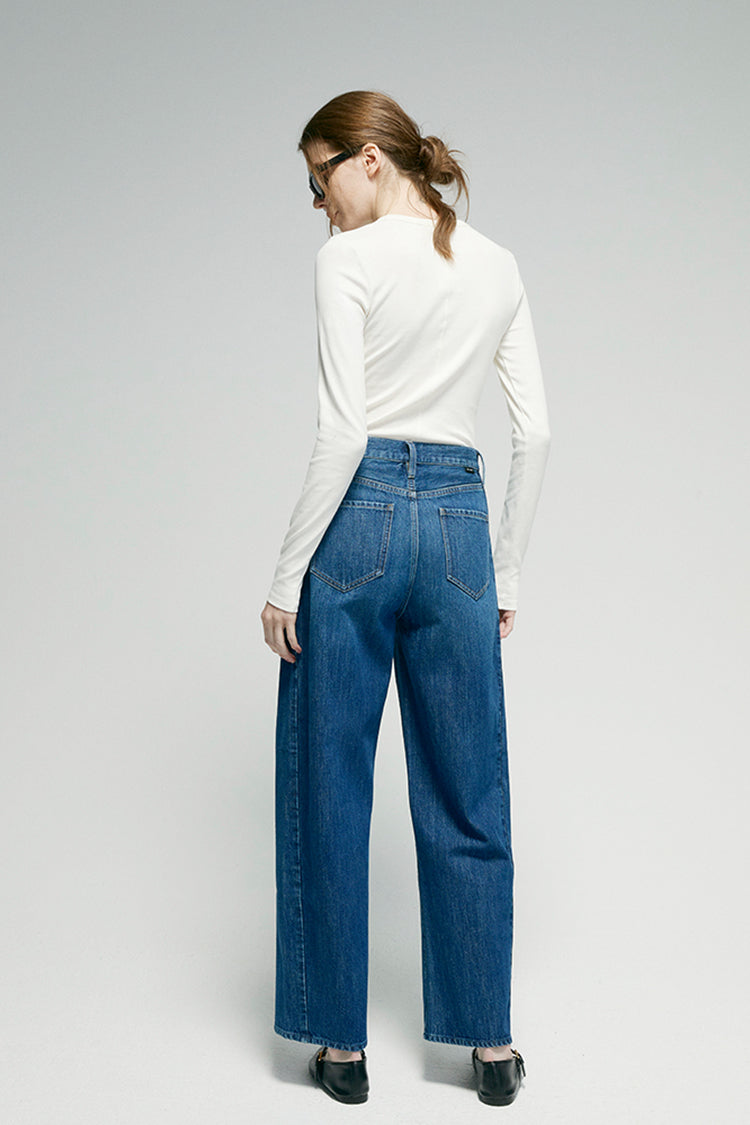 Blue denim ankle jeans, back view with yoke seam and belt loops
