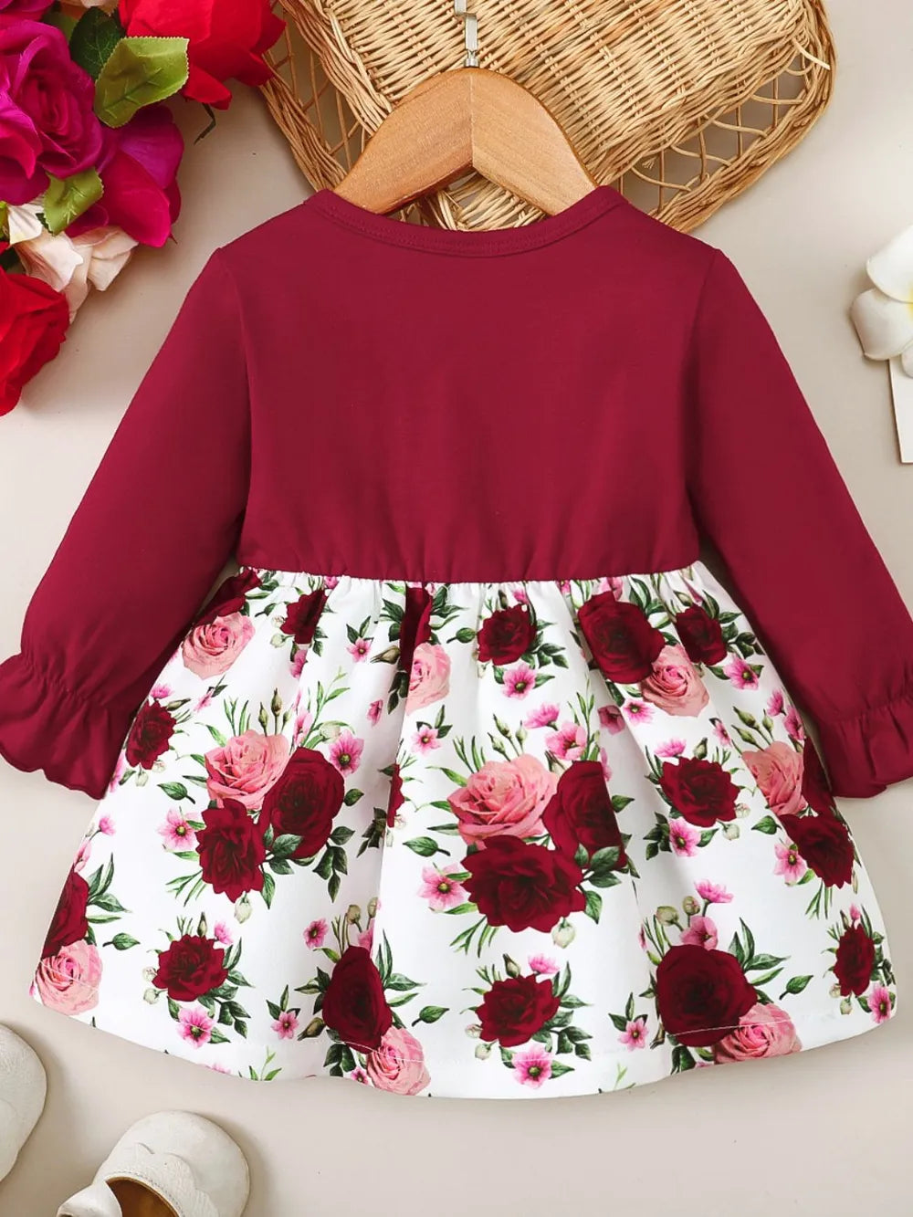 Deep red long-sleeve dress with gathered waist and floral flounce skirt hem