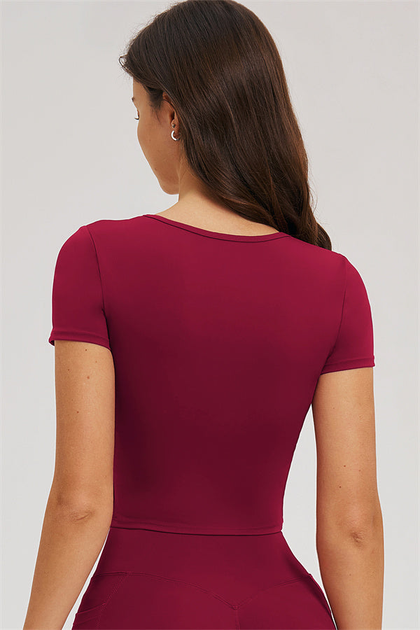 Burgundy back crop top and high-waist leggings, upper back close-up