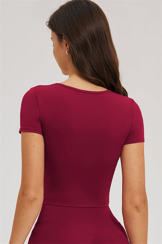 Burgundy back crop top and high-waist leggings, upper back close-up