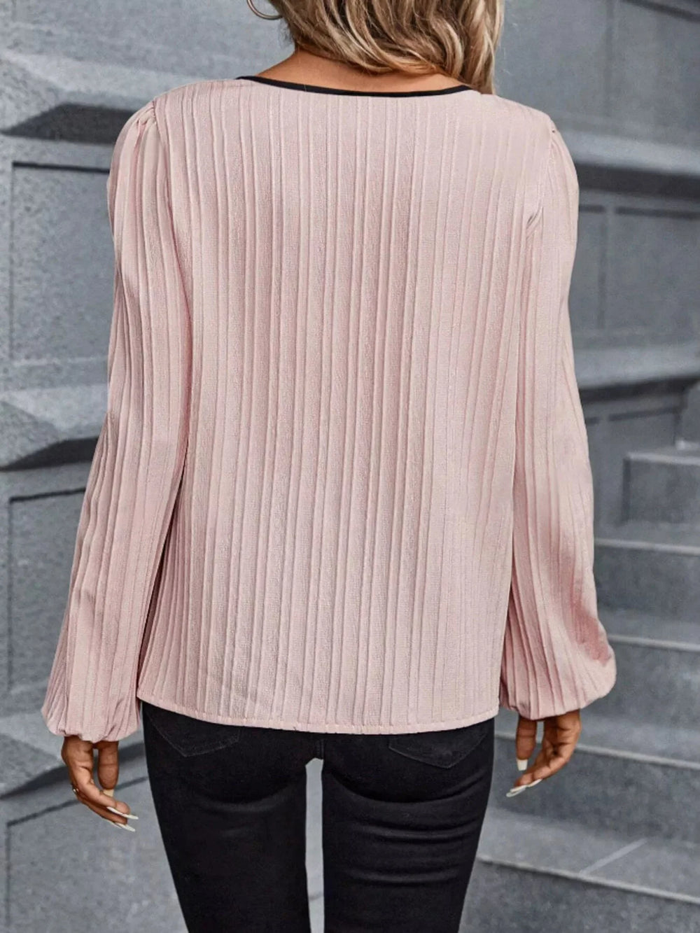 Light pink textured blouse with long sleeves and pleated back detail