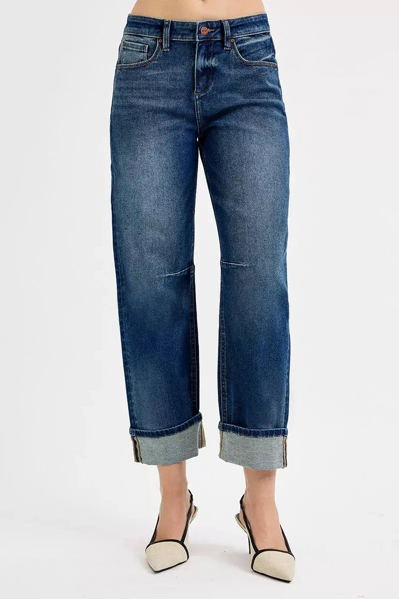 Dark wash jeans with cuffed hem, front pockets, and button closure