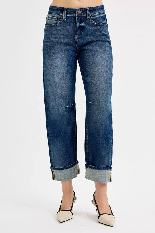 Dark wash jeans with cuffed hem, front pockets, and button closure