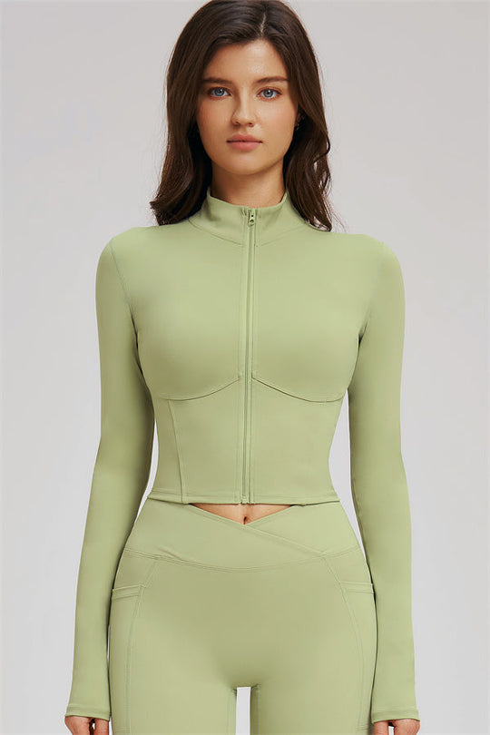 Olive green zip front cropped jacket with flared leggings and sports bra set