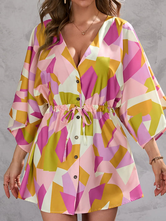 Pink-toned geometric button-up dress with tied waist and V-neck front buttons