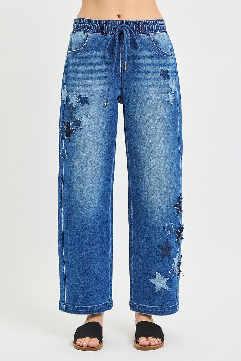 Slouchy cropped barrel jeans, dark denim with star patches and frayed detail