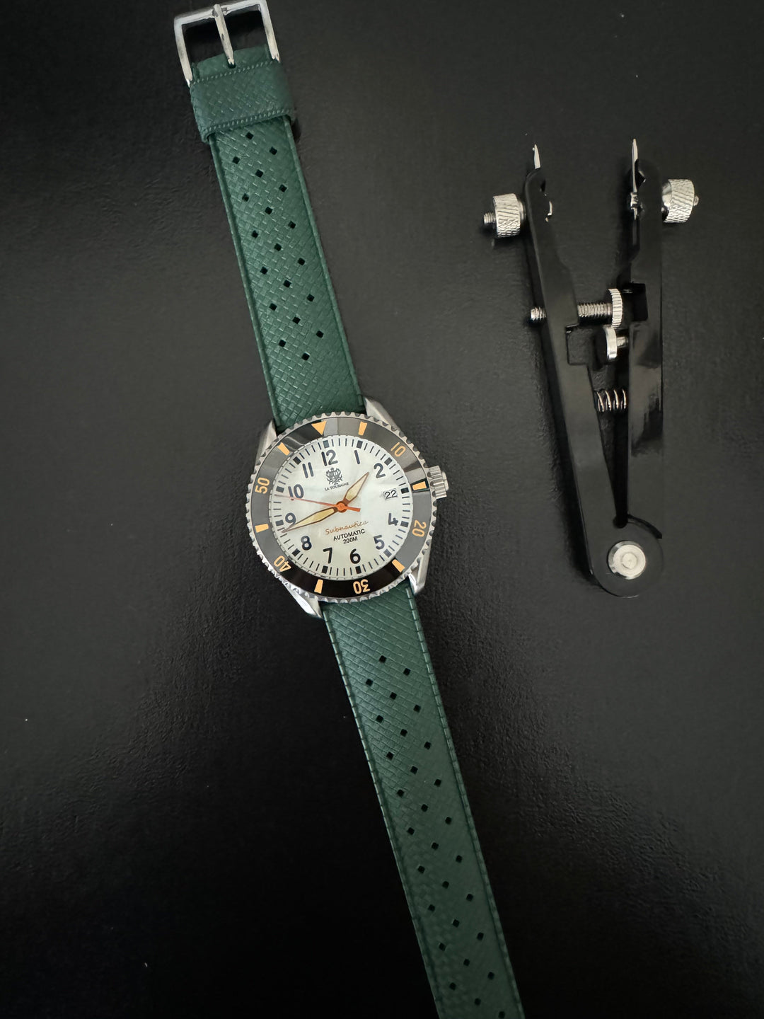 Tropic Bands watch with green perforated strap and silver buckle, white dial