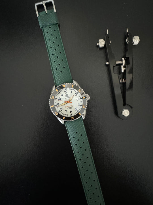 Tropic Bands watch with green perforated strap and silver buckle, white dial