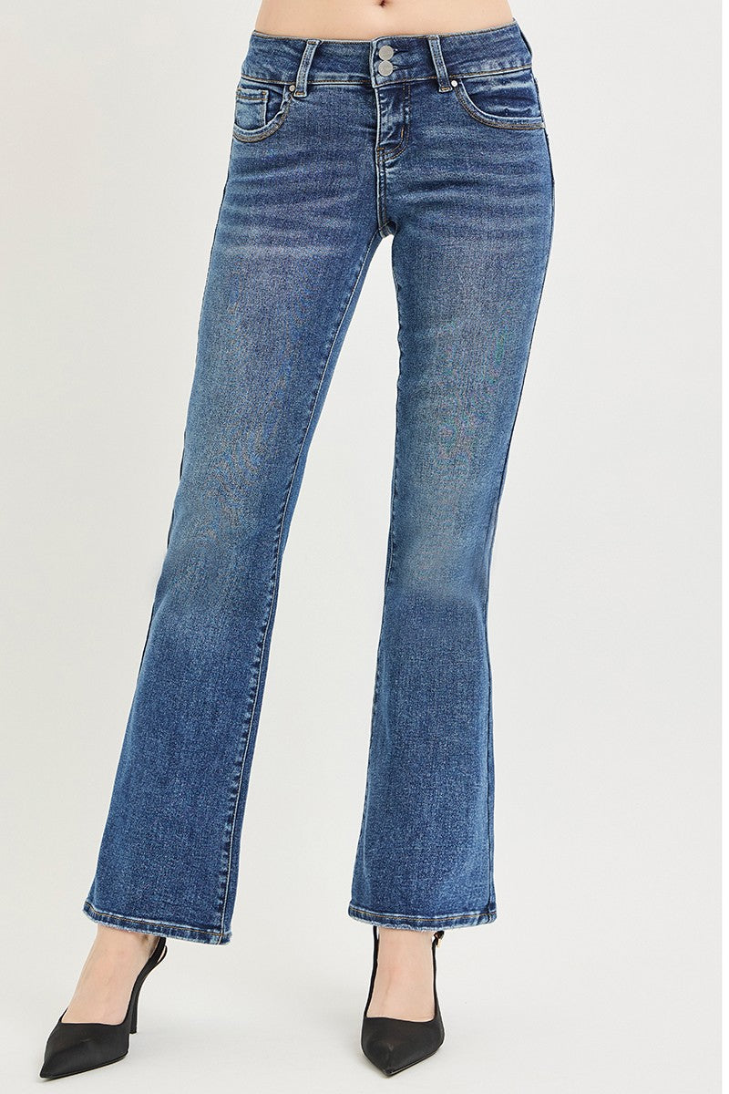 Medium wash low-rise bootcut jeans with wide leg flare and stitched cuff