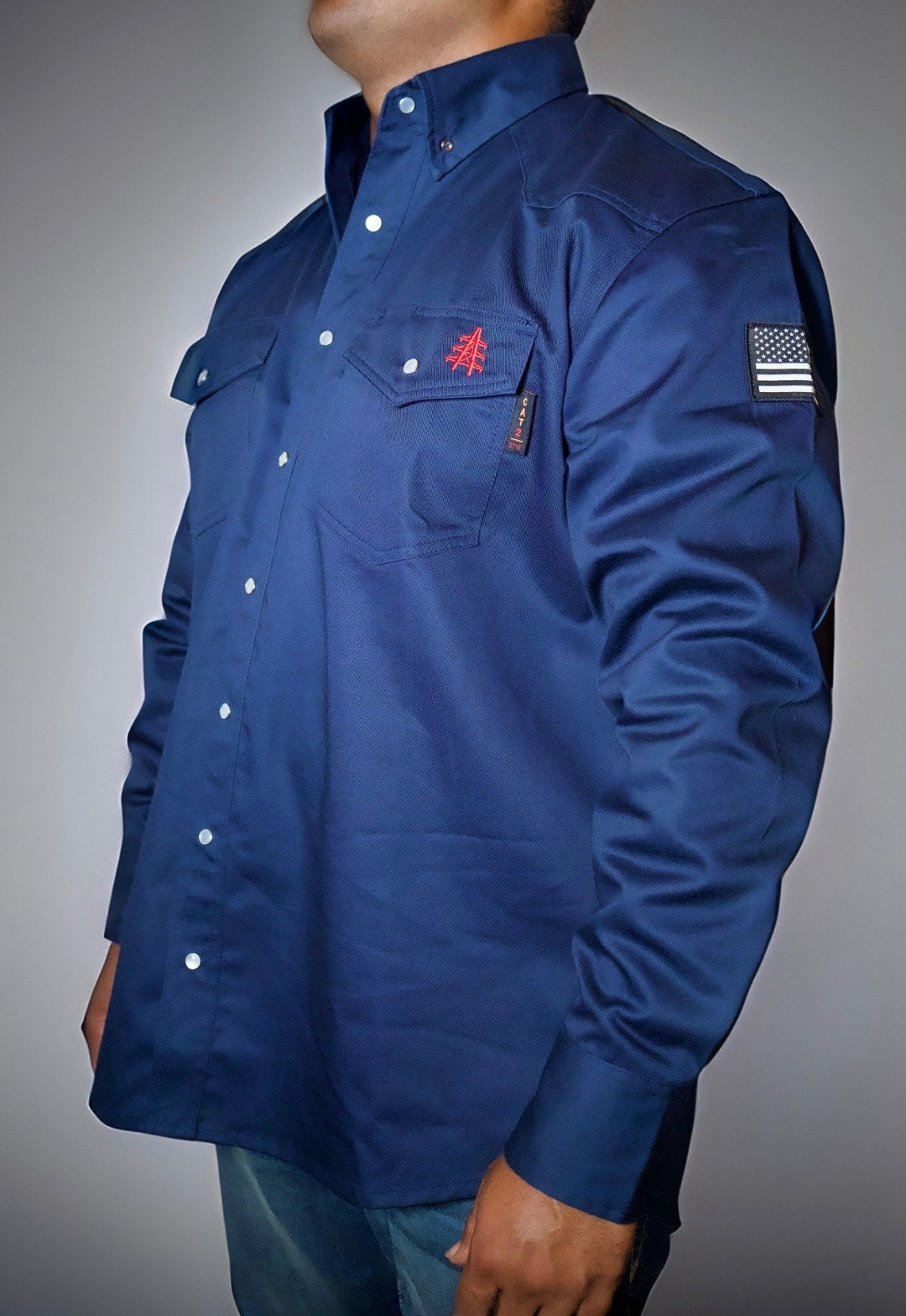 Navy FR western shirt with pearl snap front, chest pocket, and embroidered emblem