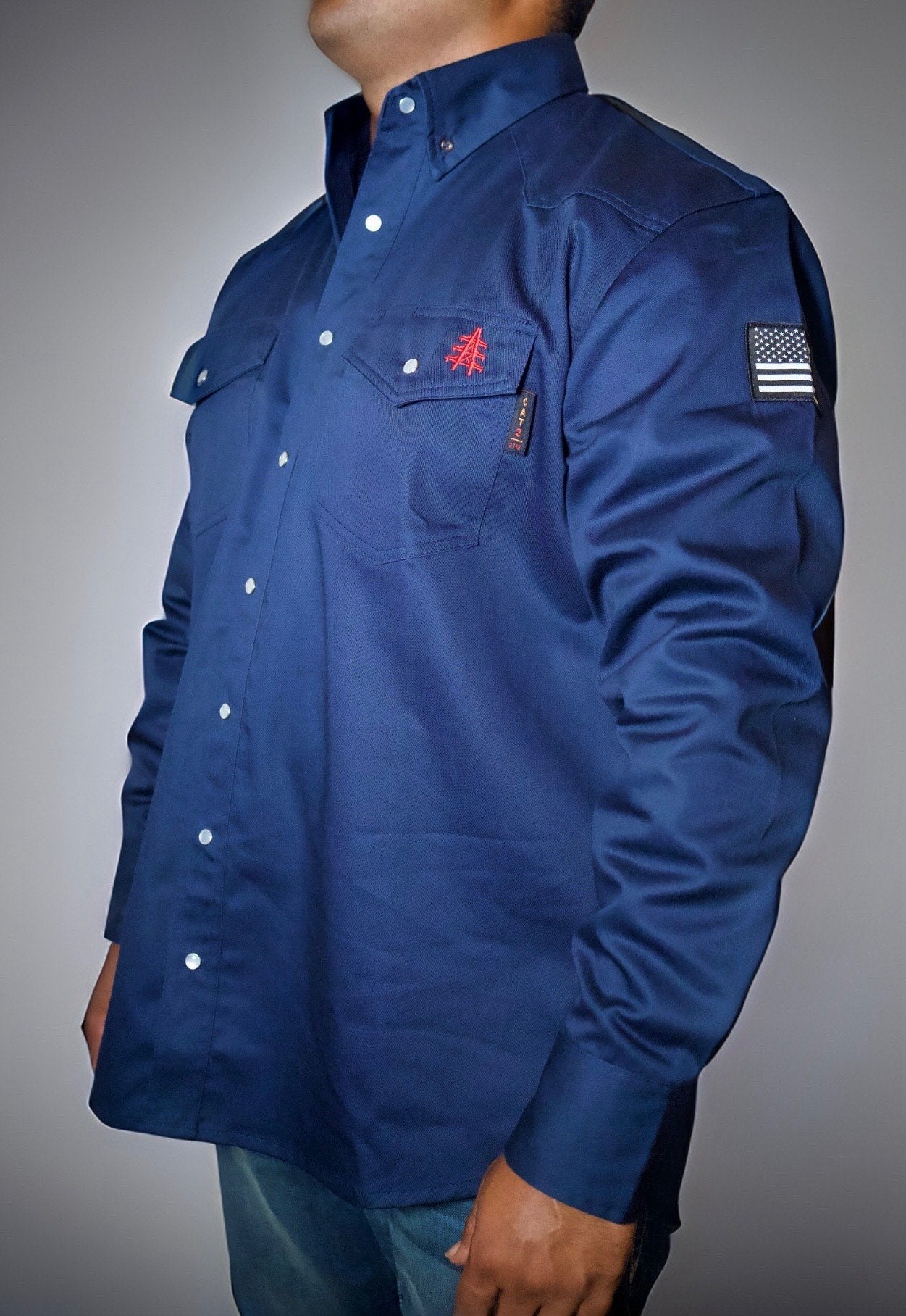 Navy FR western shirt with pearl snap front, chest pocket, and embroidered emblem