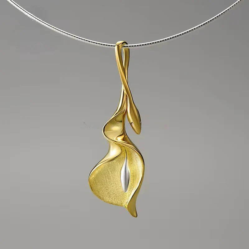 Gold calla lily pendant necklace with gold center, suspended from a silver chain