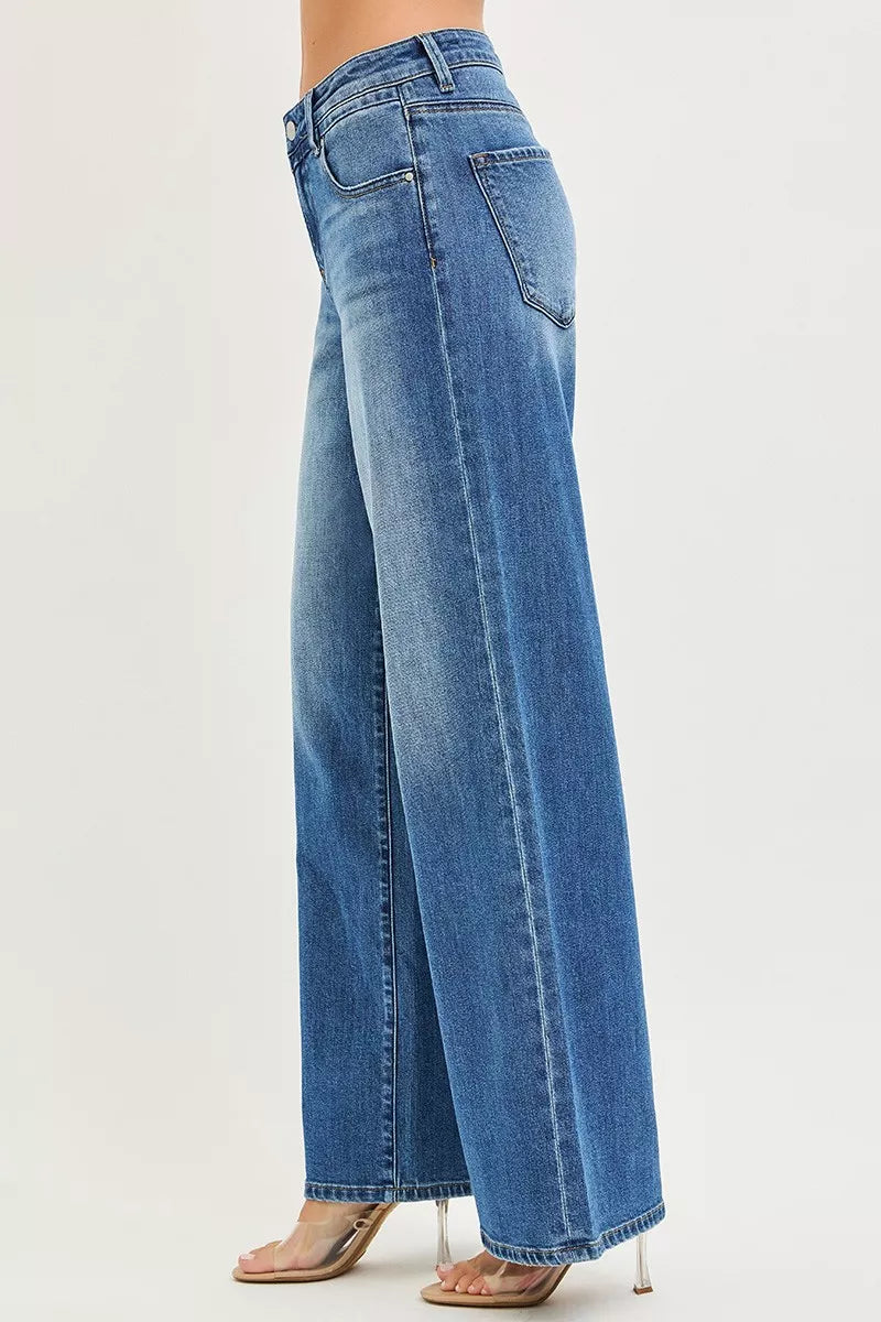 Medium-wash baggy jeans from side view with belt loops and slouchy fit