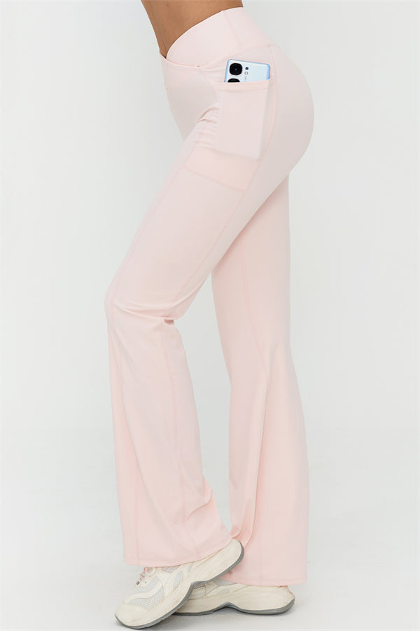Light pink flared leggings with curved side seams and wide flare hem, full length