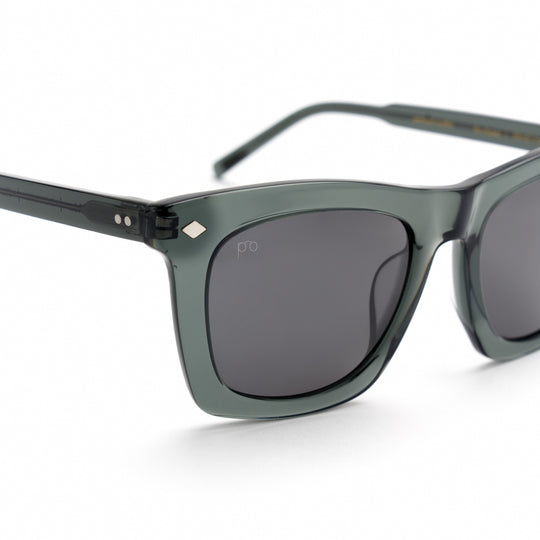 Devlin sunglasses close-up, dark green frame with curved dark lenses