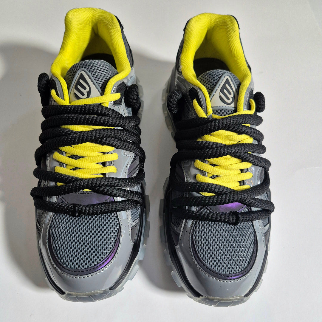 ICON V2 “Shadow” sneaker front view, yellow collar, black laces, gray panels