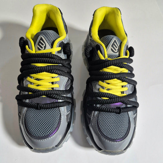 ICON V2 “Shadow” sneaker front view, yellow collar, black laces, gray panels