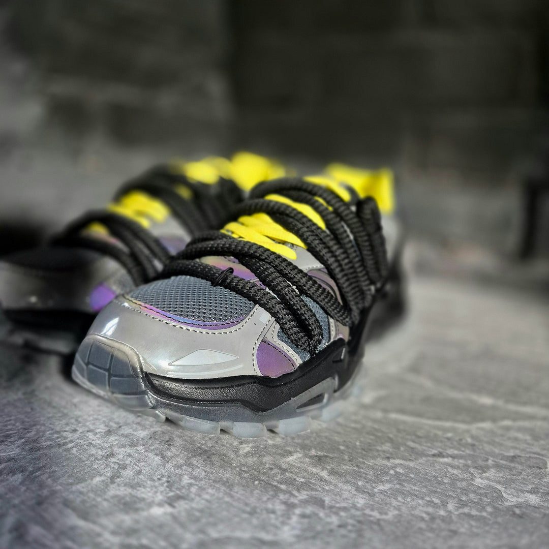 ICON V2 “Shadow” front close-up, silver-gray mesh, purple trim, yellow laces