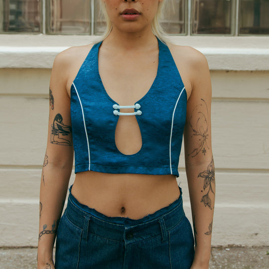 Forest blue sleeveless crop top with front keyhole cutout and white trim detail