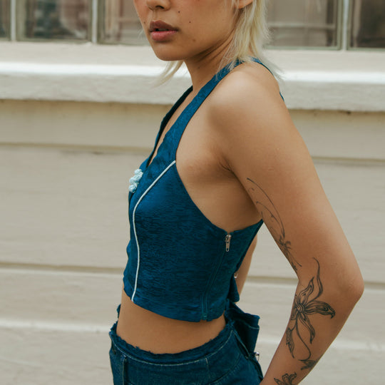 Forest blue sleeveless crop top, angled view showing back zipper and open neckline