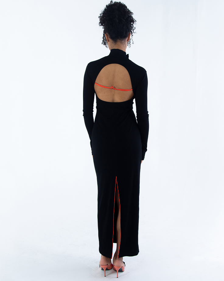 Back view black maxi dress showing open back strap and long hem slit