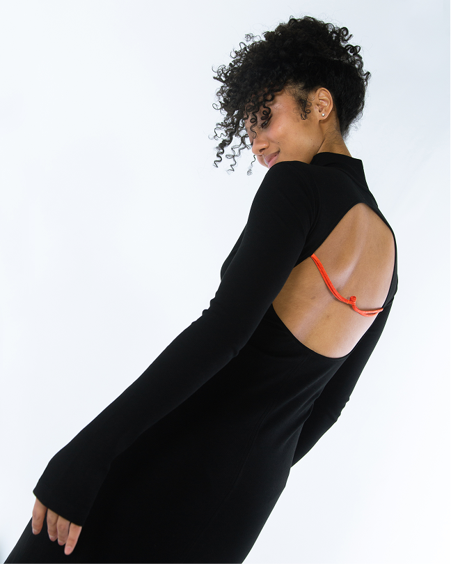 Side view black maxi dress, open back with orange tie; long sleeves