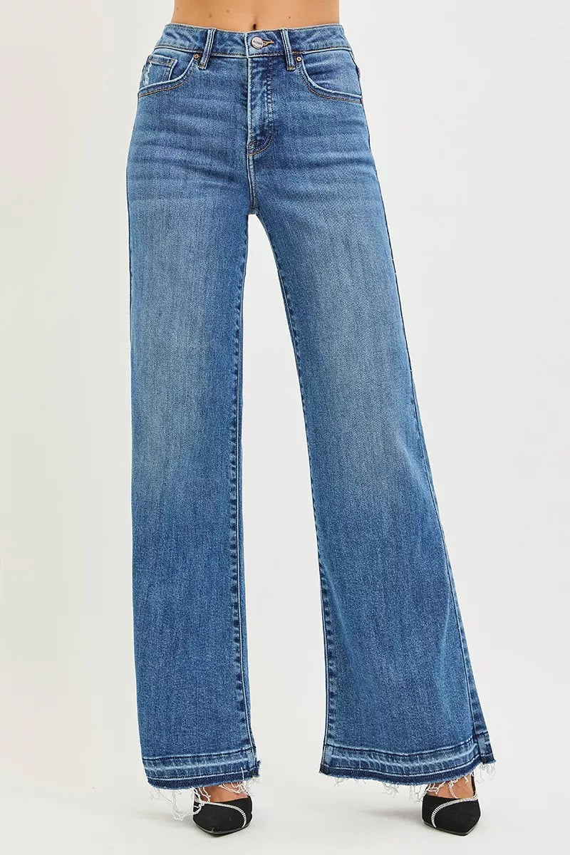 Medium wash high-rise wide-leg jeans with released, frayed hem