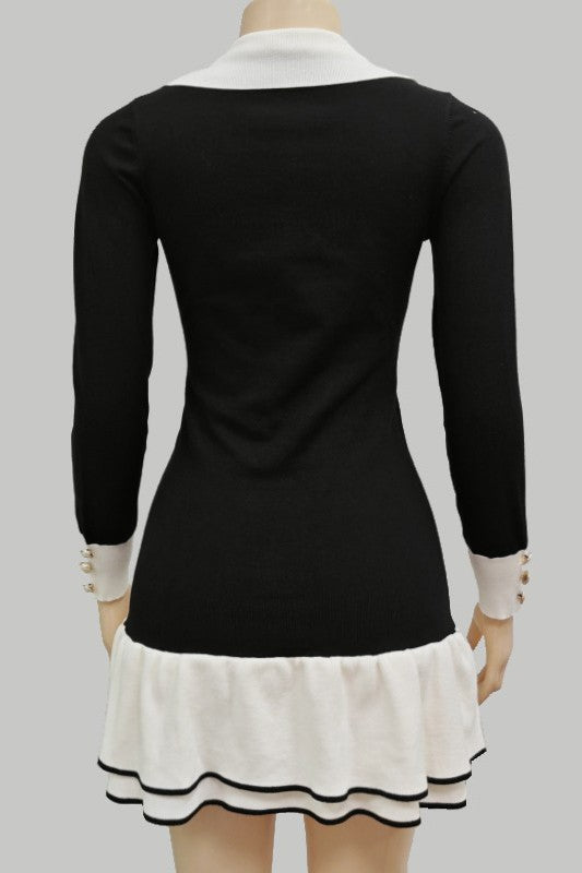 Black sweater mini dress back view with cream ruffled hem and button-cuff details