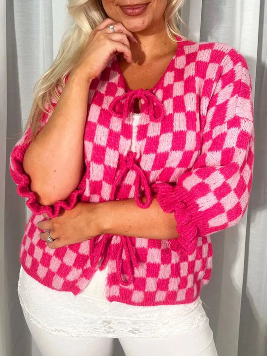 Hot pink checkered tie-front knit cardigan, ruched tie neckline and long ruffle cuffs.