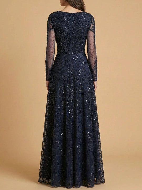 Back view of navy long sleeve high-neck gown with sequined bodice and sheer sleeves