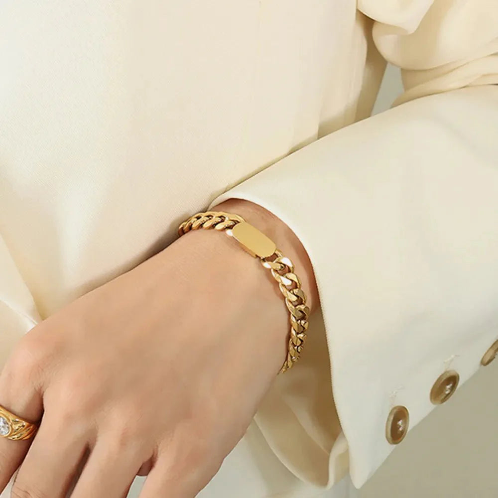 Golden Thread bracelet on wrist, gold curb-link chain with flat bar centerpiece