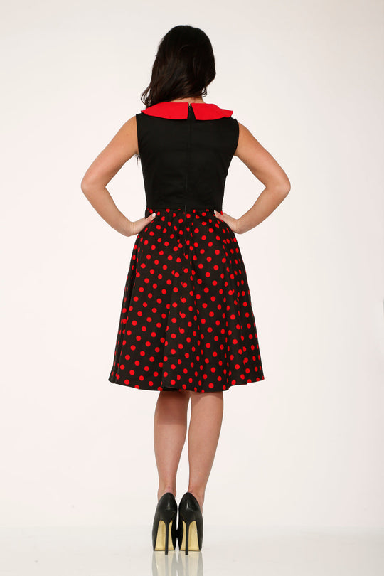 Black back view swing dress with red polka dot skirt and red collar