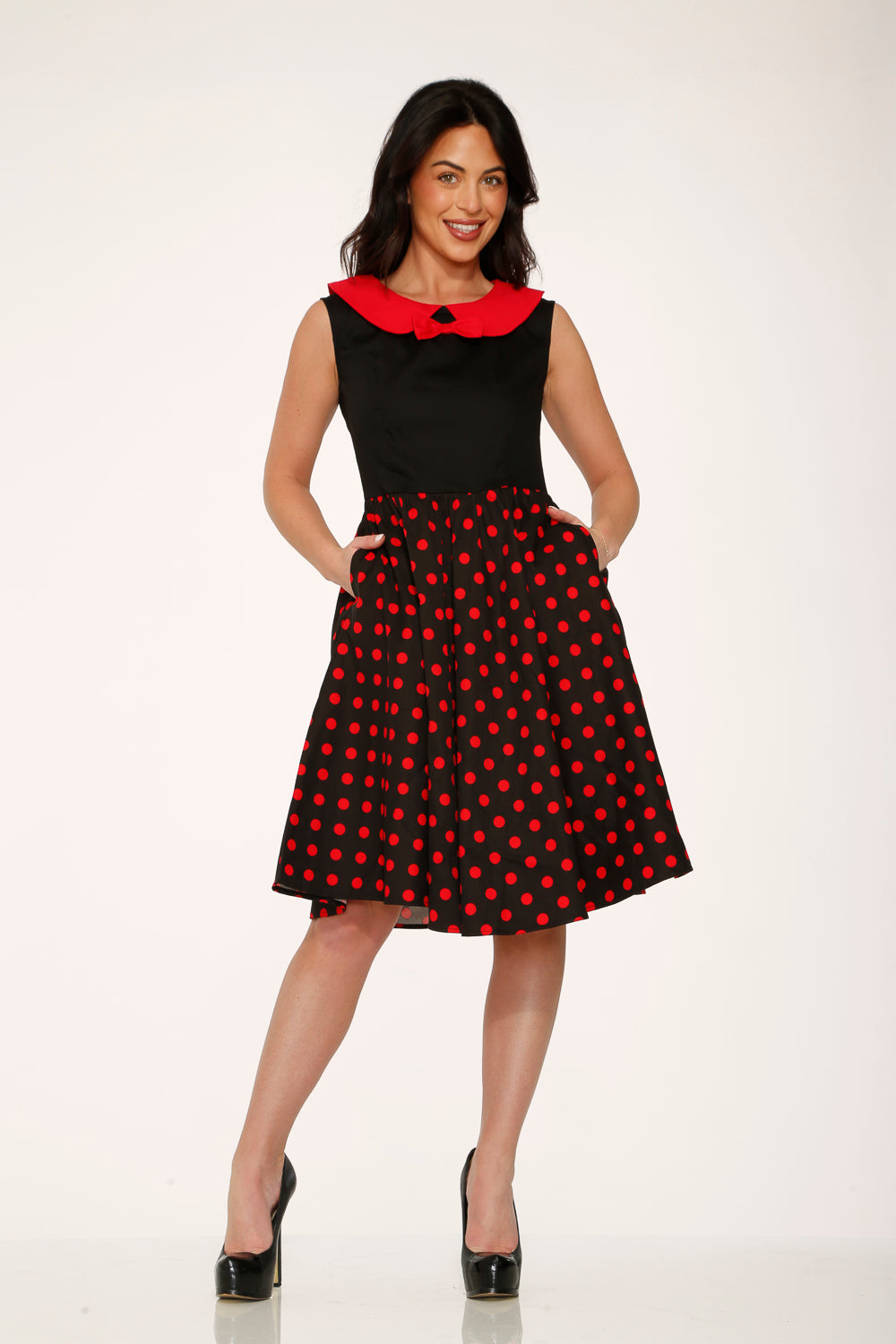 Black swing dress with red polka dot skirt and red collar, front 3/4 view