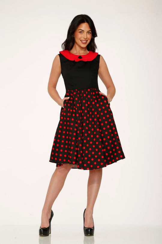 Black swing dress with red polka dot skirt and red collar, front 3/4 view