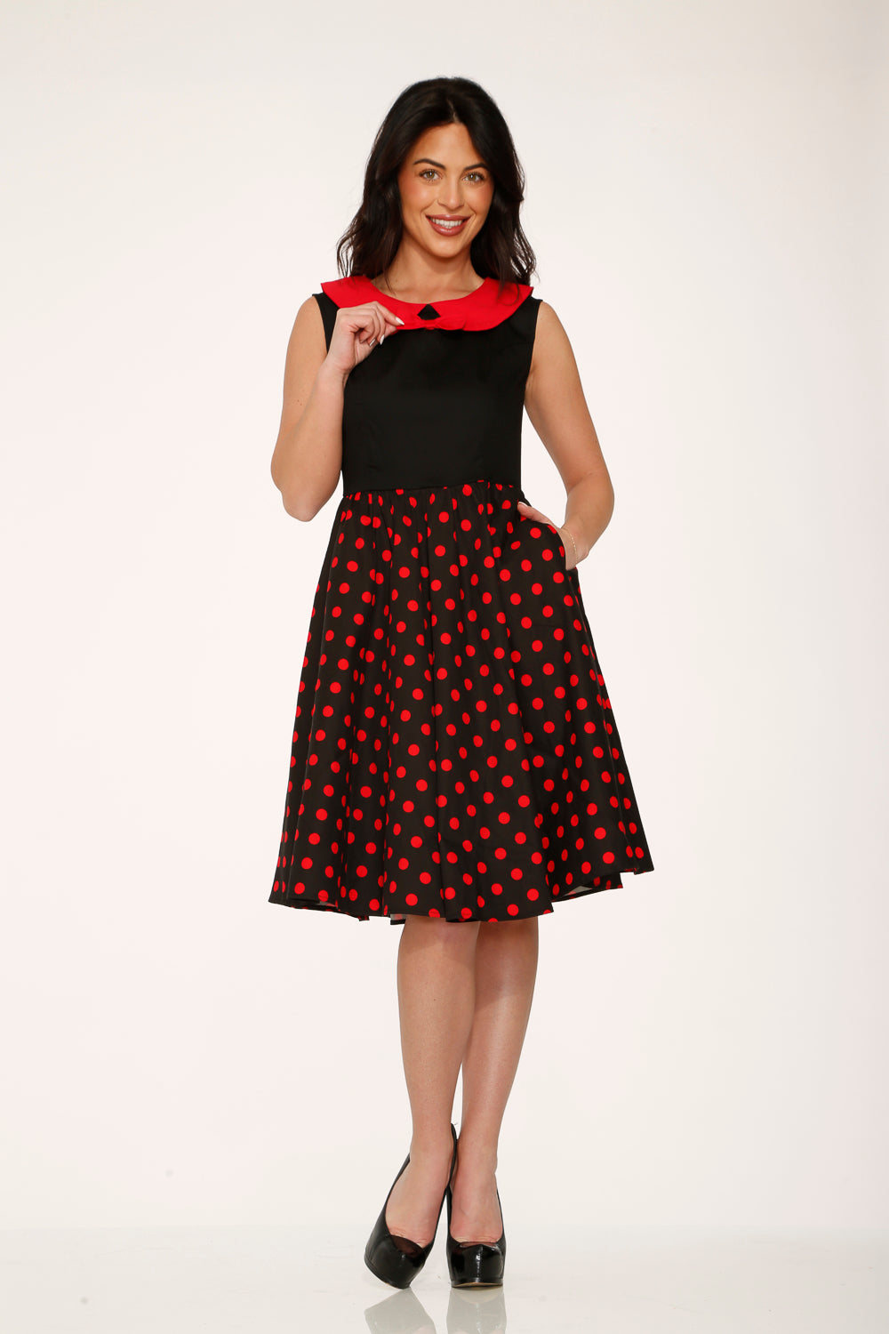 Black sleeveless swing dress with red collar and red polka dot mid skirt