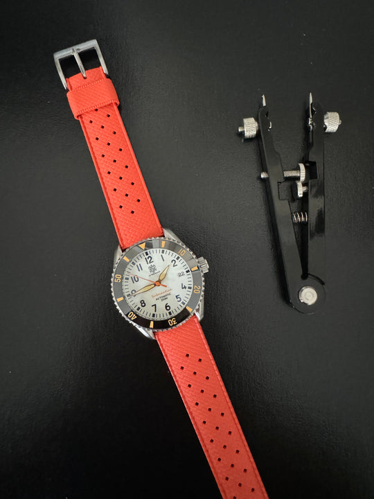 Tropic Bands watch with orange-red perforated strap and silver buckle, white dial