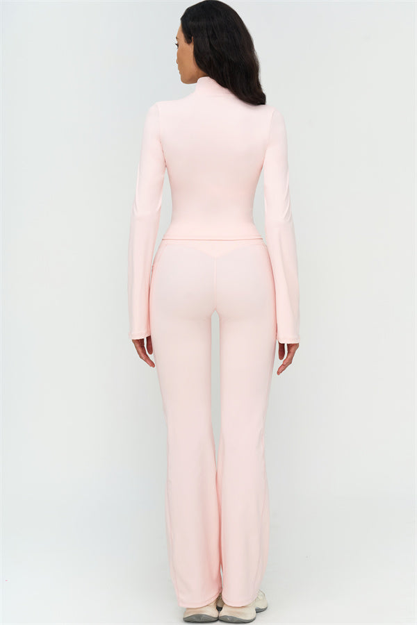 Back view of light pink flared leggings with high-rise waistband and long bell-bottom legs