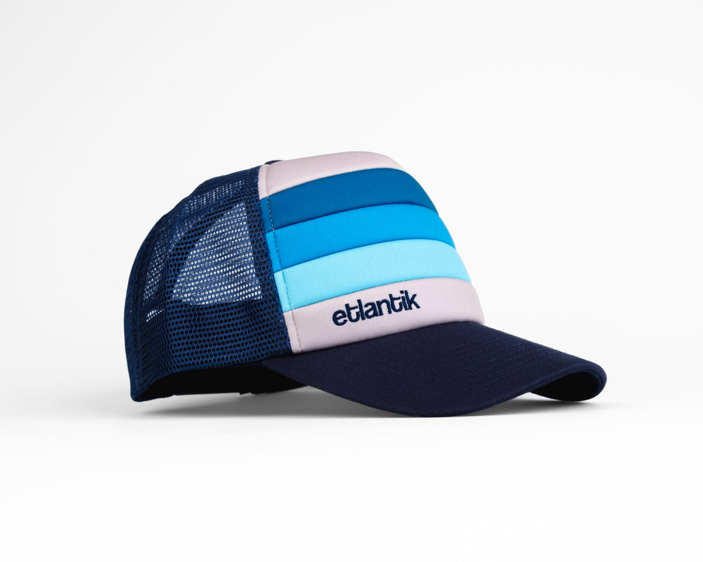 Swell Cap Blue: navy mesh cap with light-blue stripe panels and logo patch on side.