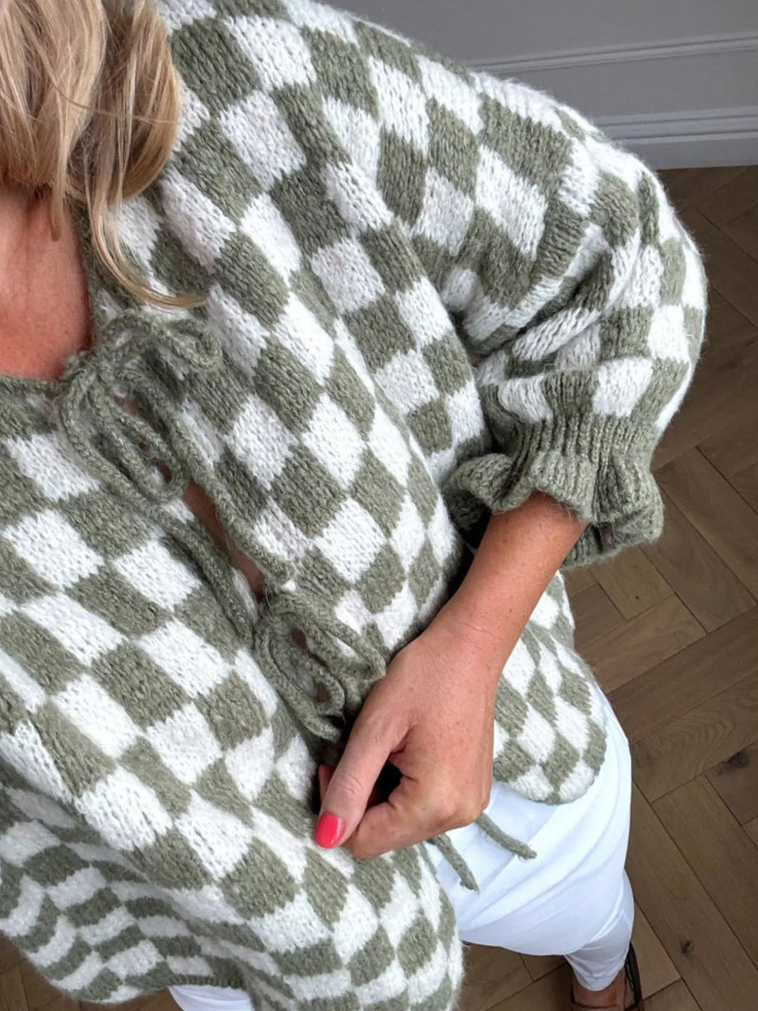 Matcha green checkered tie-front knit cardigan close-up with ruffled sleeve trim.