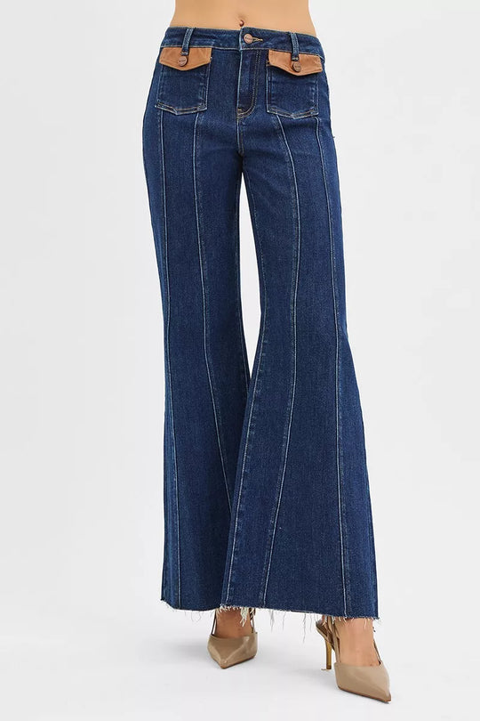 Dark high-rise wide-flare jeans with centered seam detail and back patch pockets