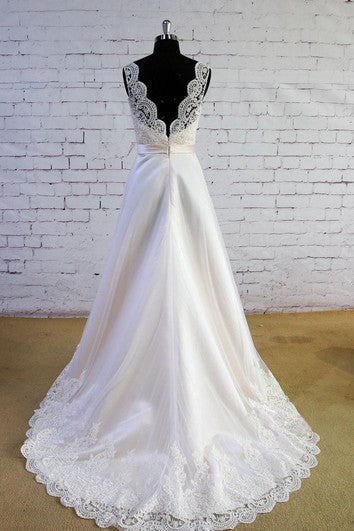 Ivory satin A-line dress with lace V-neck, waist sash, and lace-trimmed hem