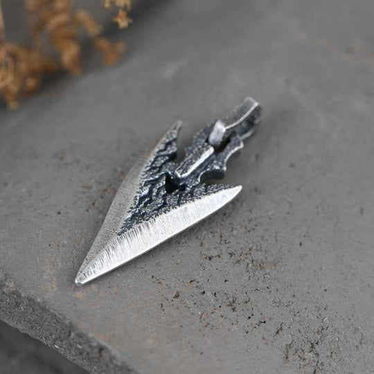 Silver weapon-shaped pendant necklace, side view of dagger with dark center detail