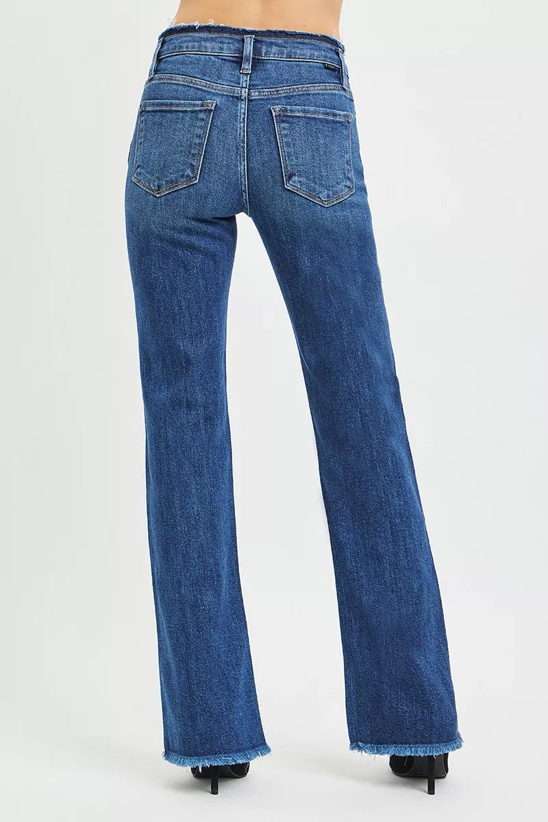Dark blue jeans back view with two patch pockets and frayed hem