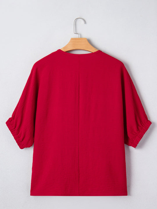 Deep Red half-sleeve blouse back view on hanger with relaxed shoulders